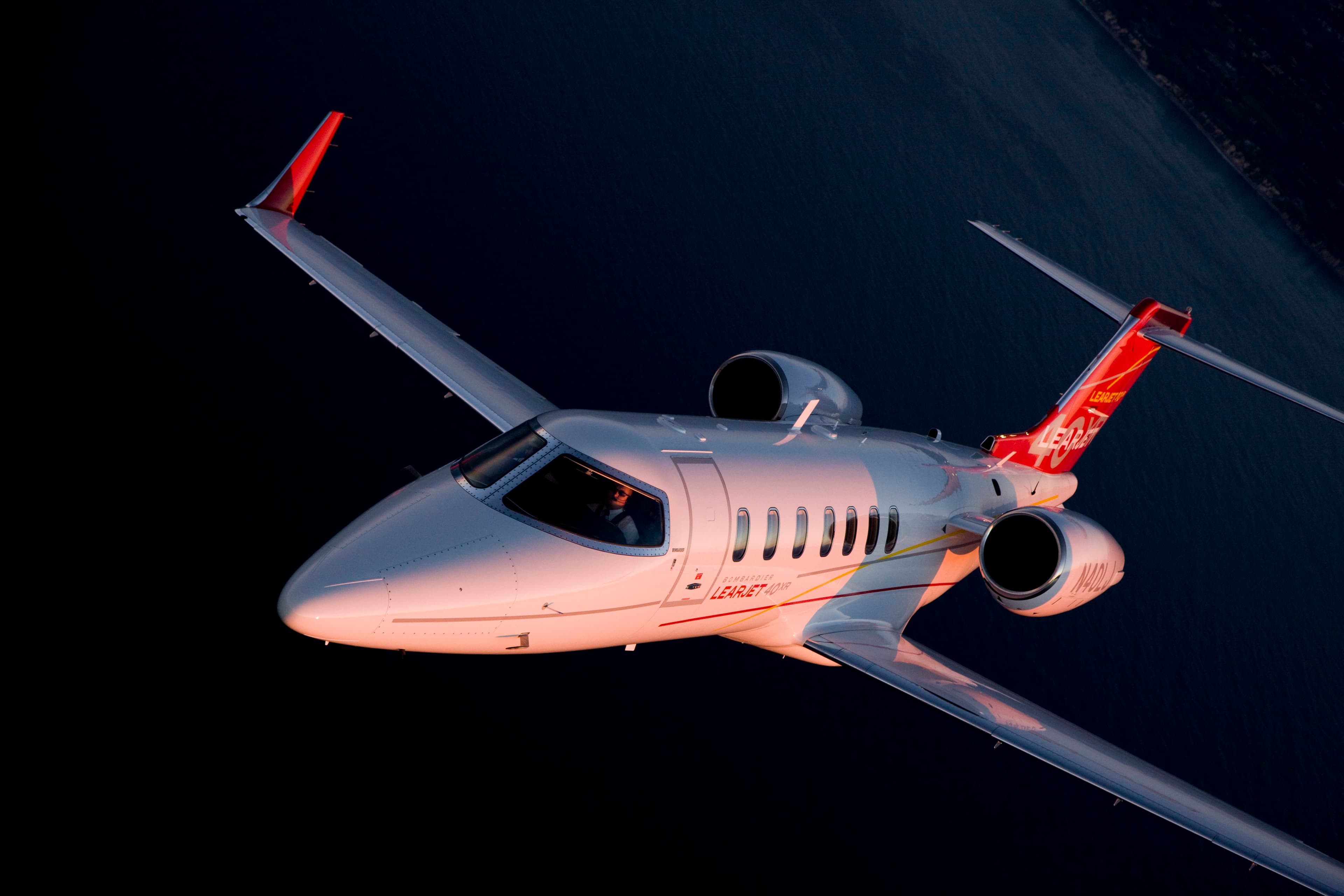 Learjet 40XR flying over water